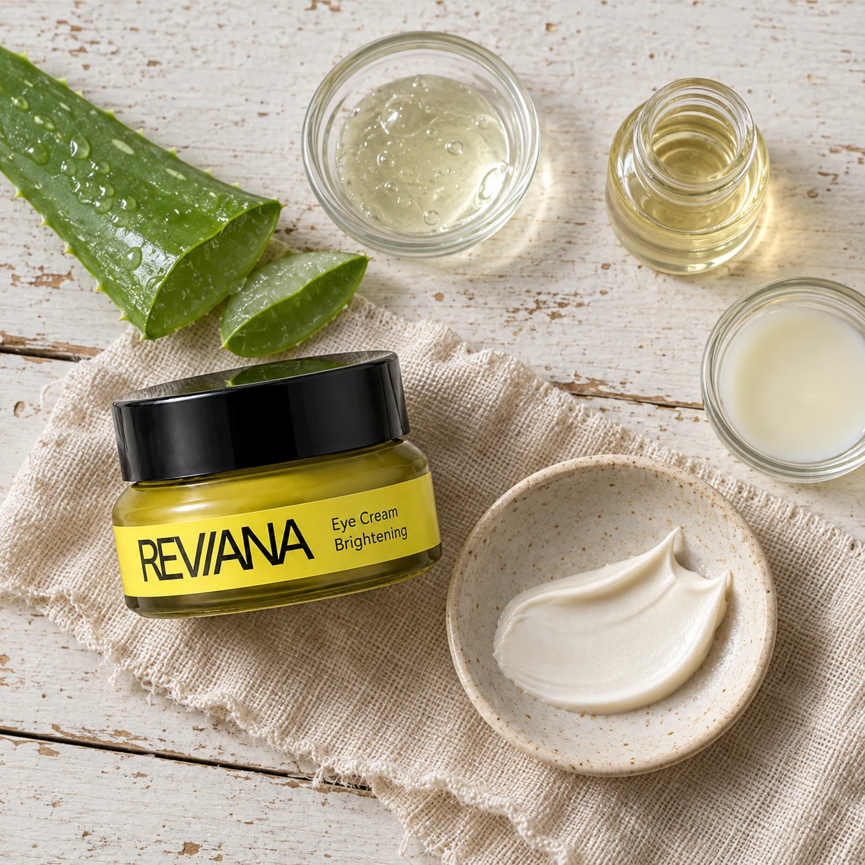 Reviana Eye Cream ingredient flatlay with aloe, oils and cream