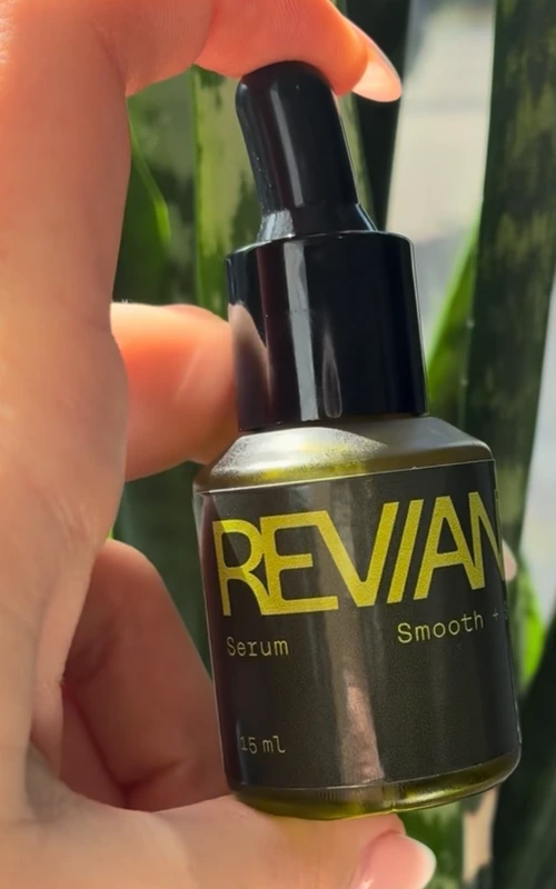 The Reviana Serum bottle in hand