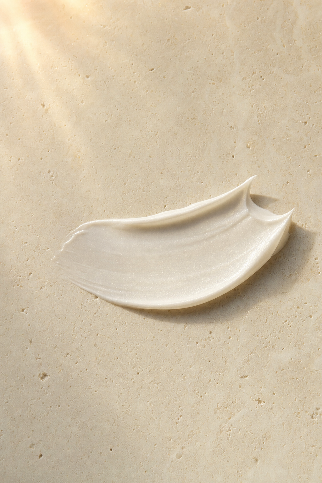 A pearl-white swipe of the cream on warm stone